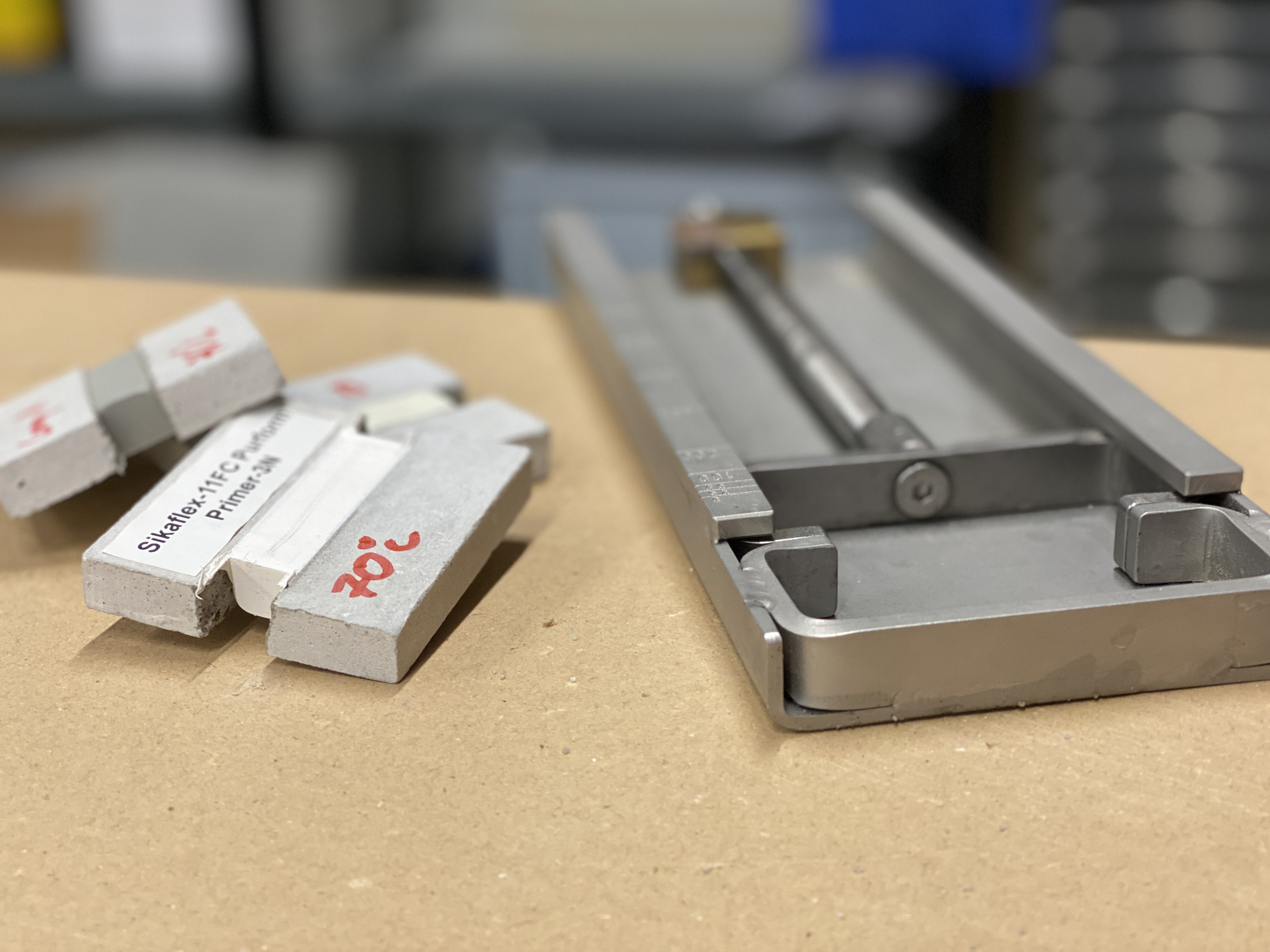 Close up of Sikaflex® 11-FC Purform® primer sample in lab testing with tool